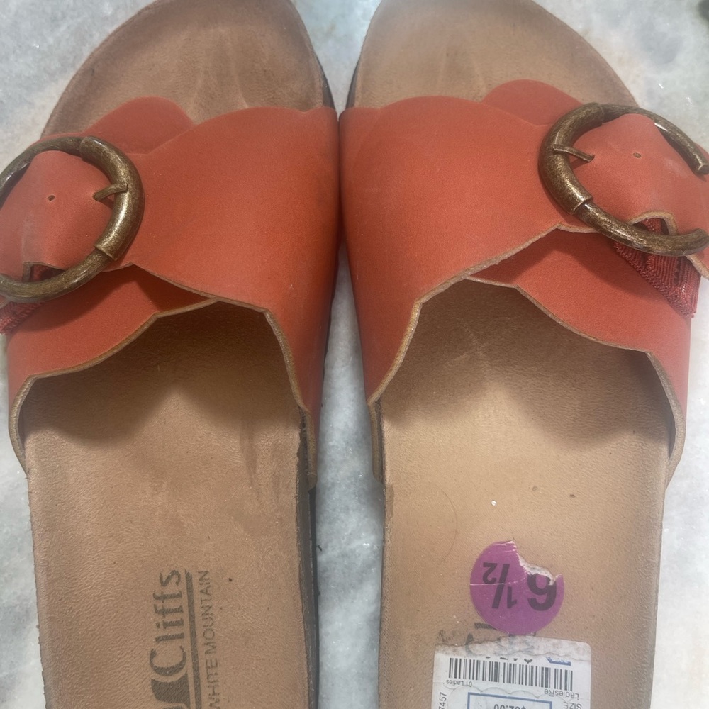 Slip on orange sandals by Cliffs